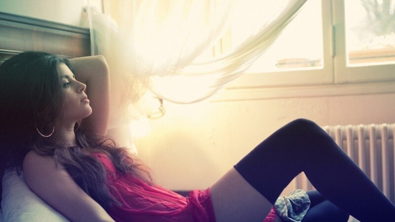 woman in red shirt on bed