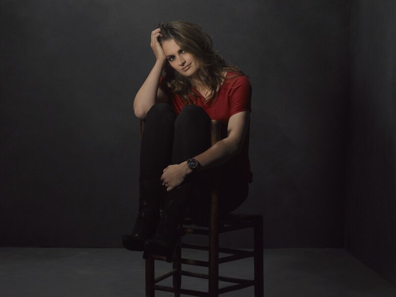 woman in red shirt sitting on chair