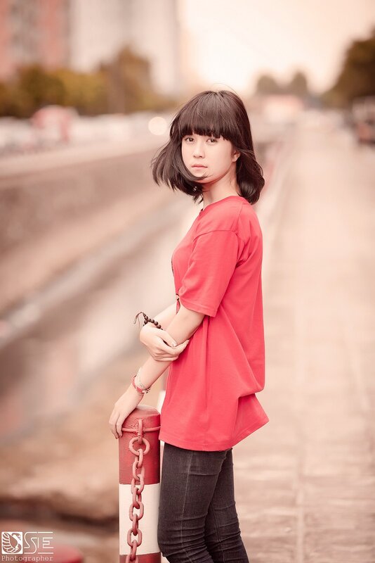 woman in red shirt standing