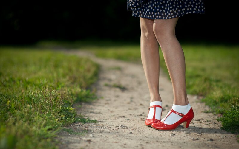 woman in red shoes on path
