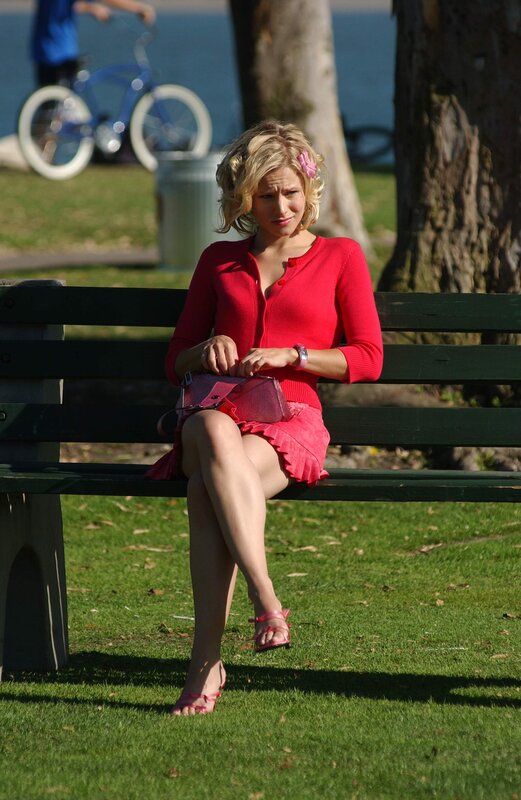 Woman in red sitting on a bench