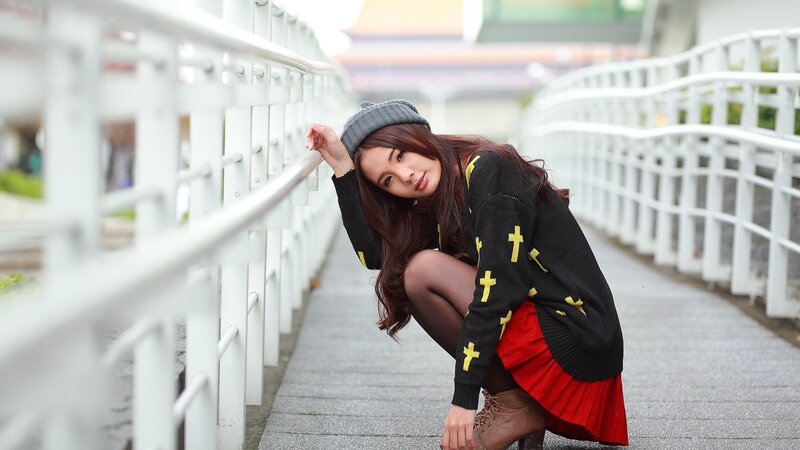 woman in red skirt crouching