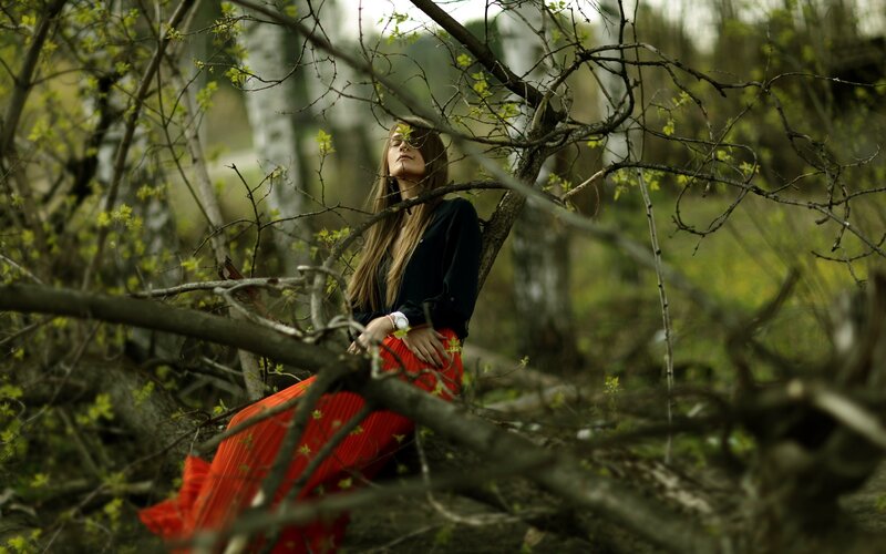 woman in red skirt in forest