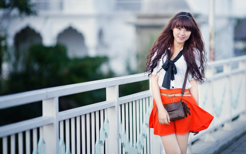 woman in red skirt on bridge