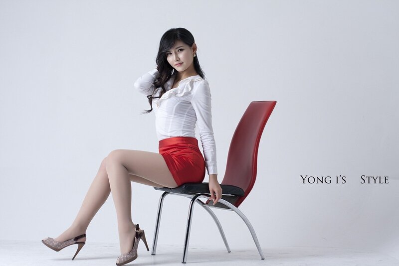 woman in red skirt sitting on chair