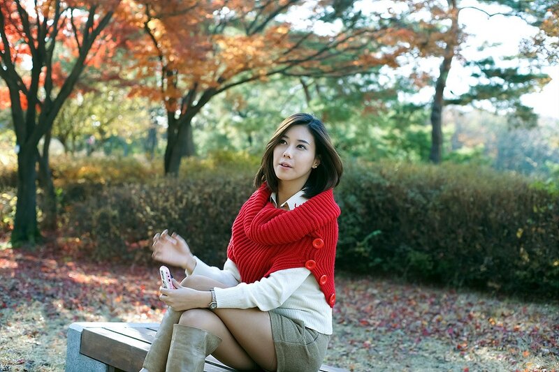 Woman in red sweater at park