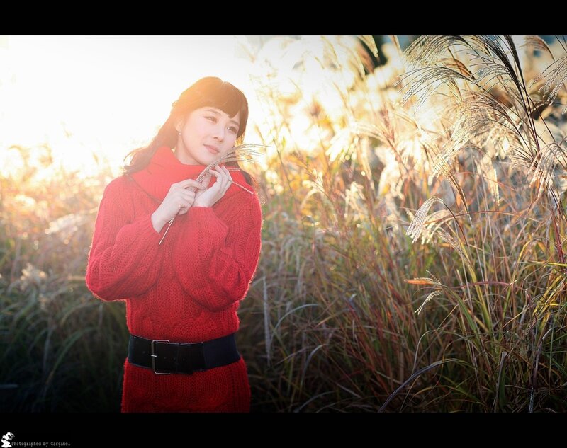 Woman in red sweater at sunset