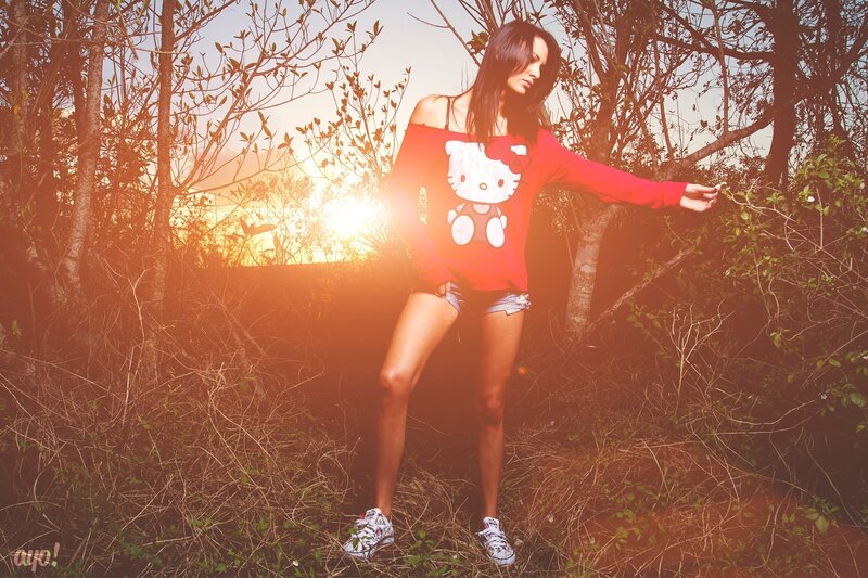 Woman in red sweater at sunset