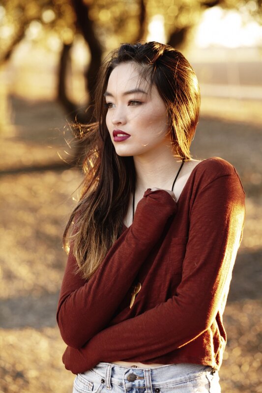 woman in red sweater at sunset