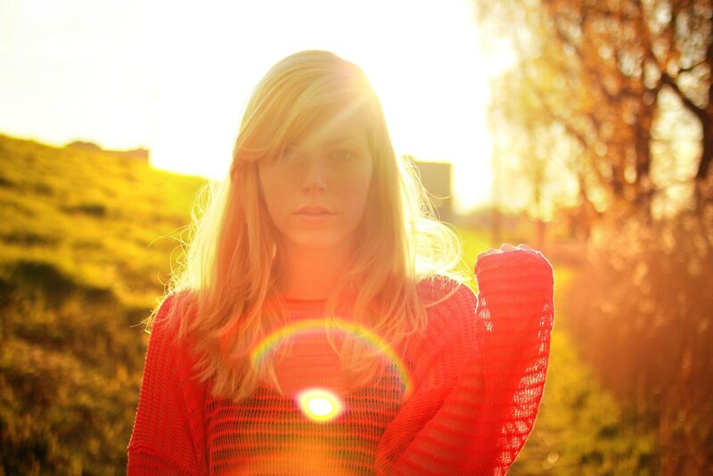 woman in red sweater at sunset