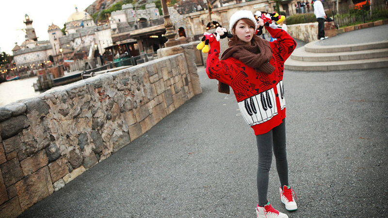 Woman in red sweater at theme park