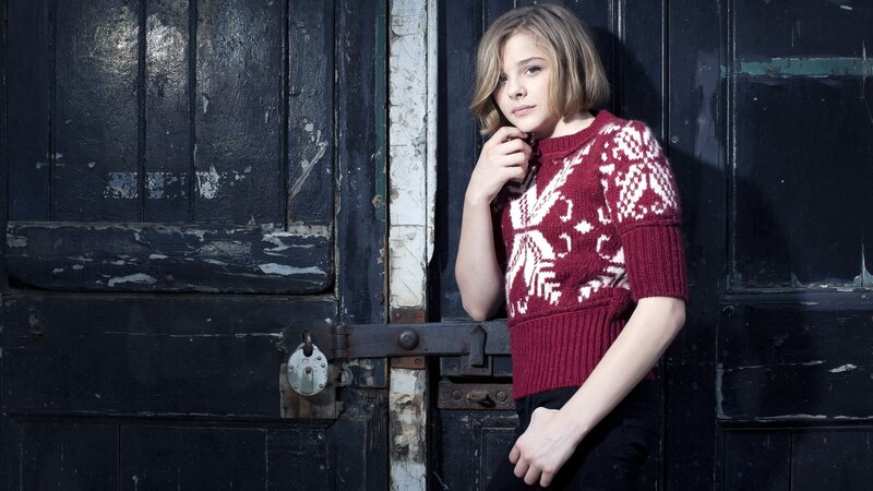woman in red sweater by door