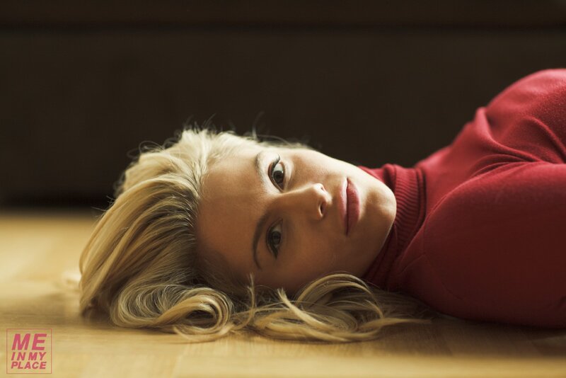 woman in red sweater lying on floor