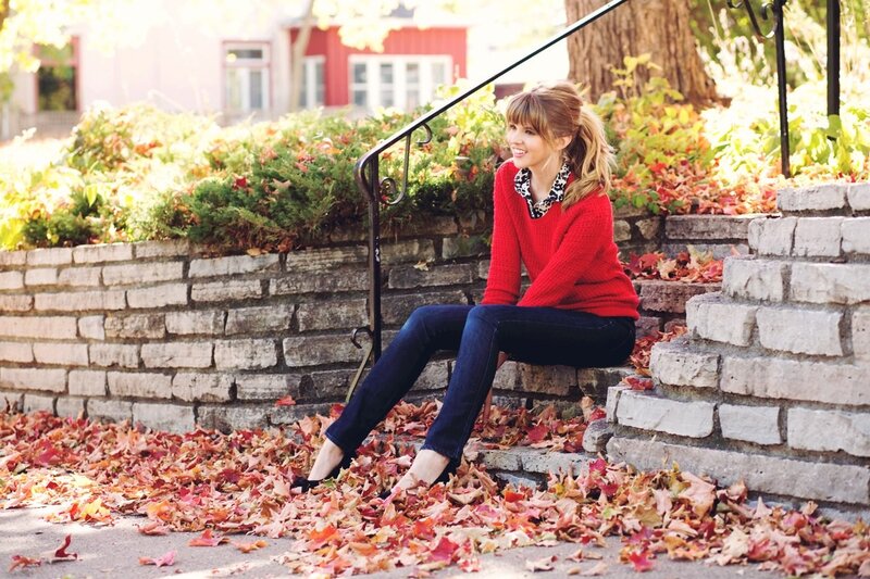 Woman in red sweater on autumn steps