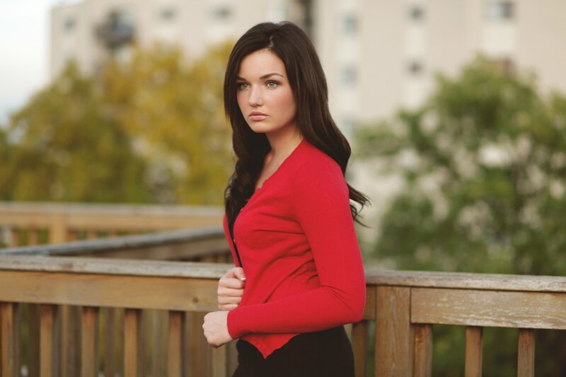 woman in red sweater on balcony