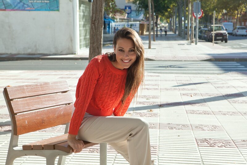 Woman in red sweater on bench
