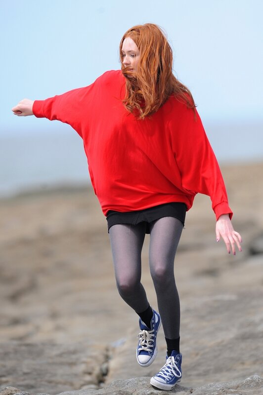 Woman in red sweater on rocks