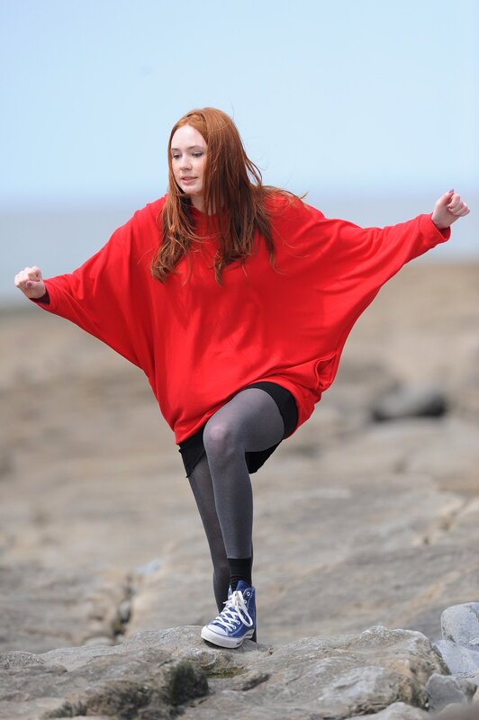 Woman in red sweater on rocks