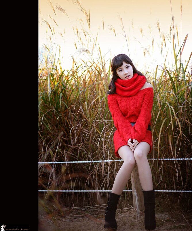 Woman in red sweater sitting