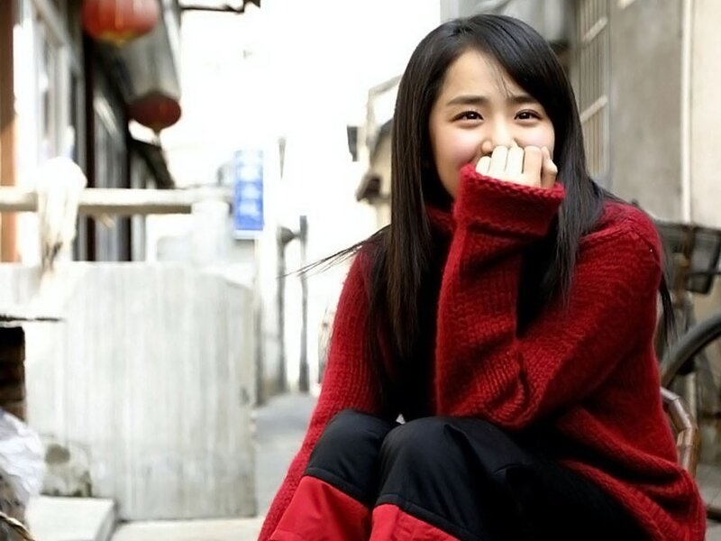 woman in red sweater smiling