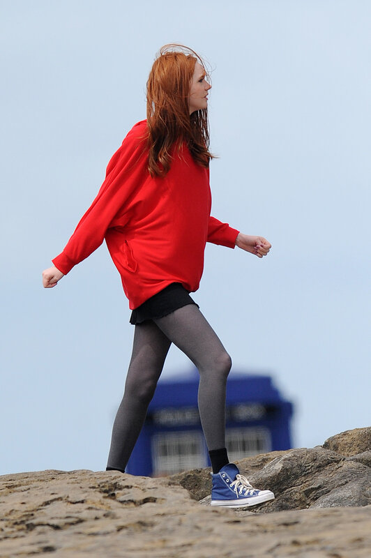 Woman in red sweater walking