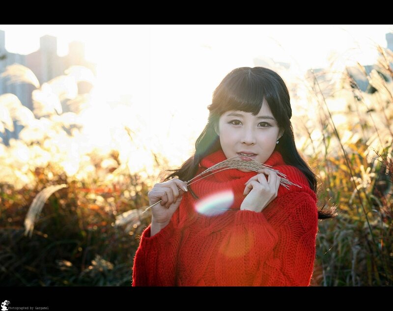Woman in red sweater with reeds