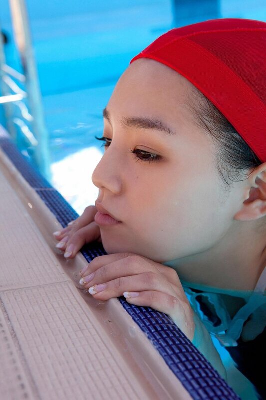 woman in red swim cap at pool
