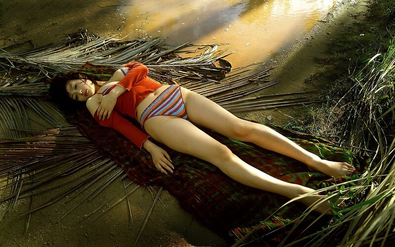 Woman in red swimsuit lying on ground
