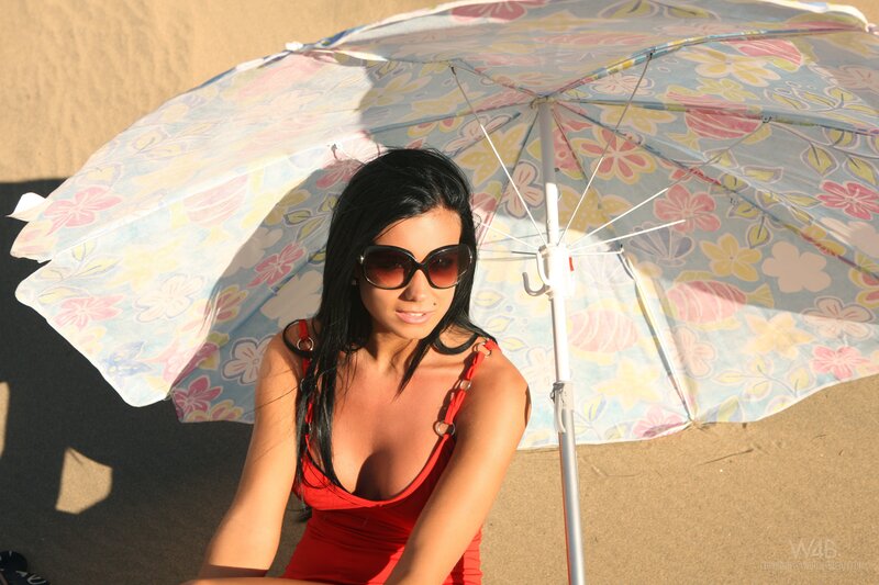 woman in red swimsuit under umbrella