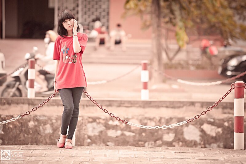 woman in red t-shirt standing