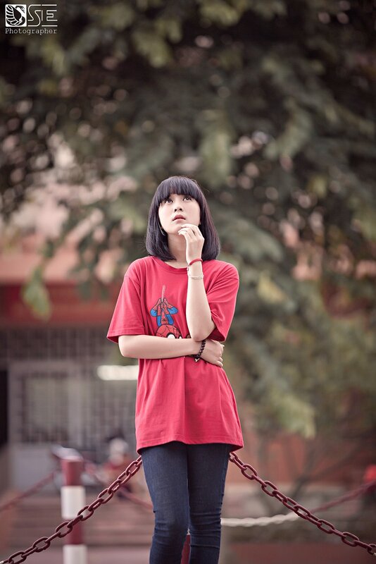 Woman in red t-shirt thinking