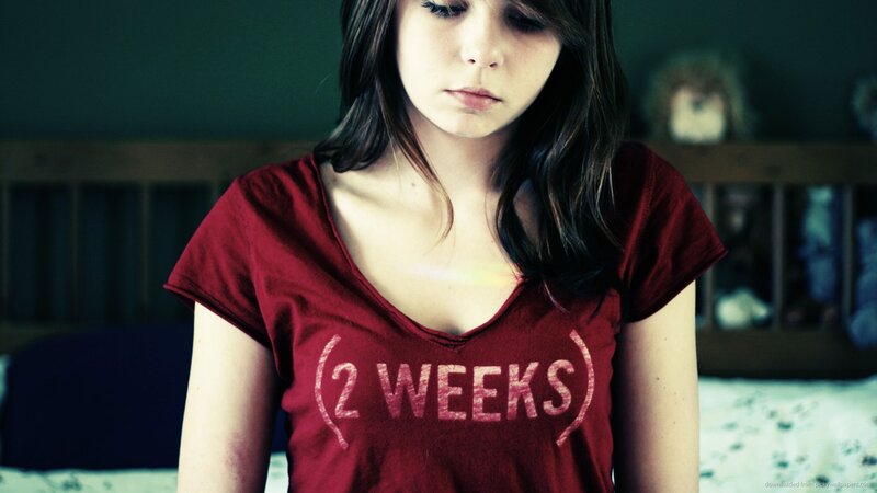 woman in red t-shirt with text
