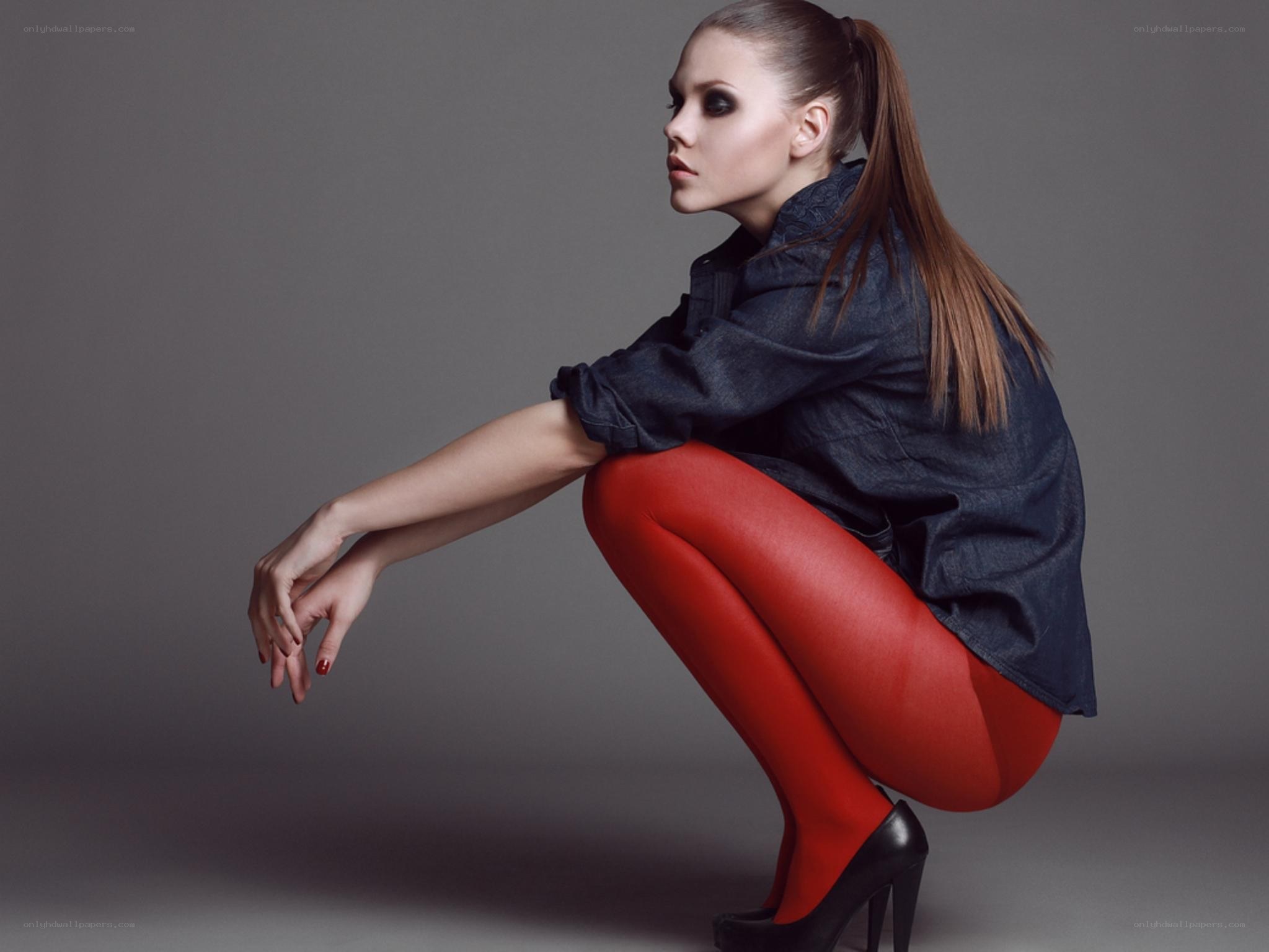 woman in red tights crouching