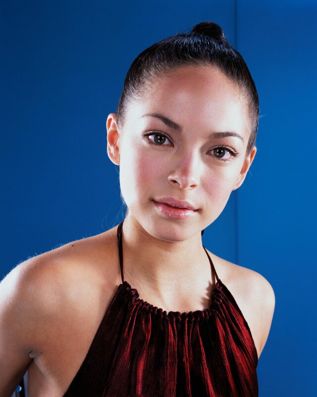 woman in red top against blue background