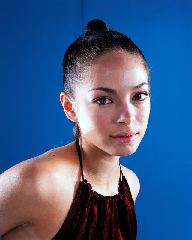 woman in red top against blue background
