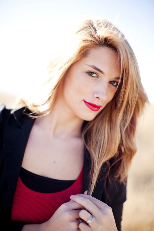 woman in red top and black blazer