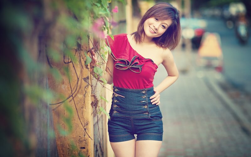 woman in red top and denim shorts
