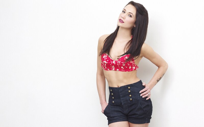 woman in red top and denim shorts