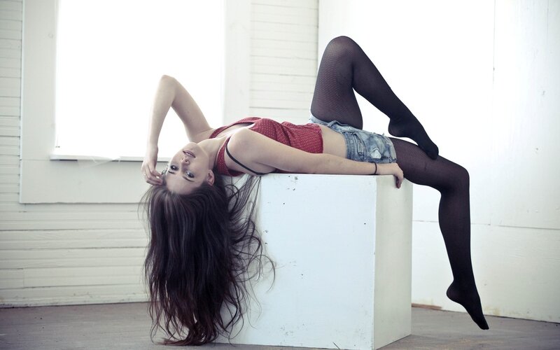 woman in red top and fishnet tights
