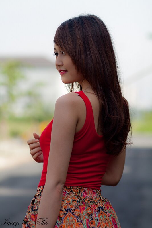 woman in red top and patterned skirt