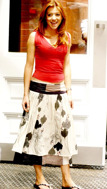 woman in red top and patterned skirt