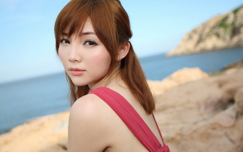 woman in red top at seaside