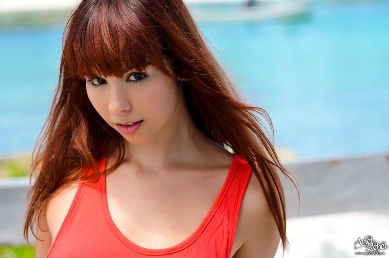 woman in red top by pool