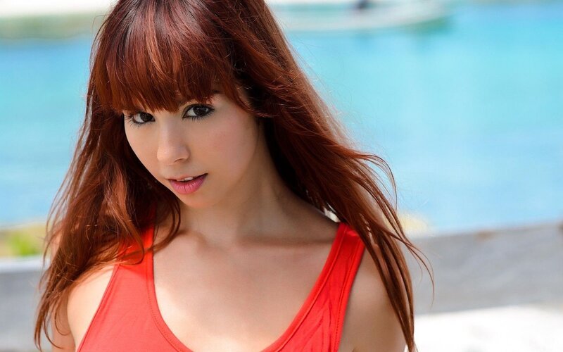 woman in red top by pool
