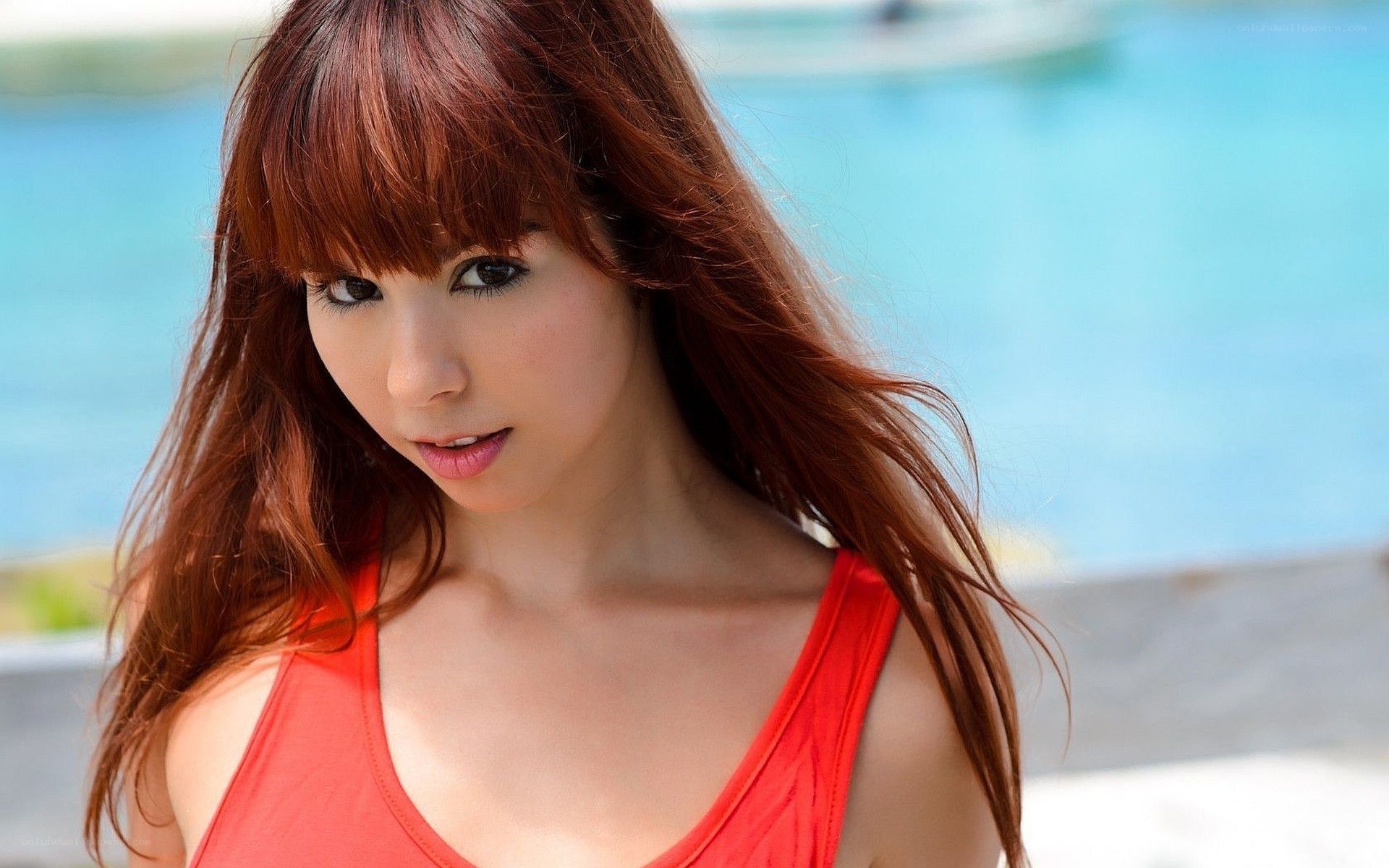 woman in red top by pool