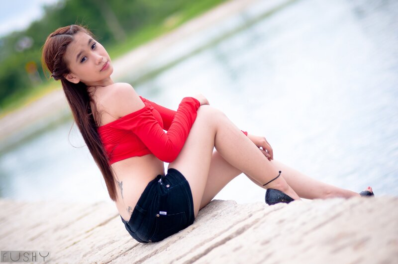 Woman in red top by water