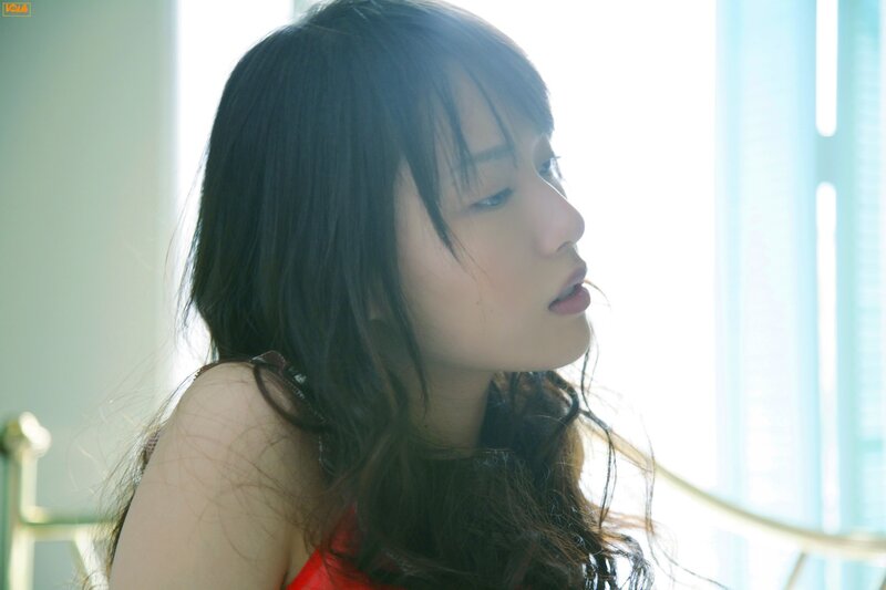 woman in red top by window