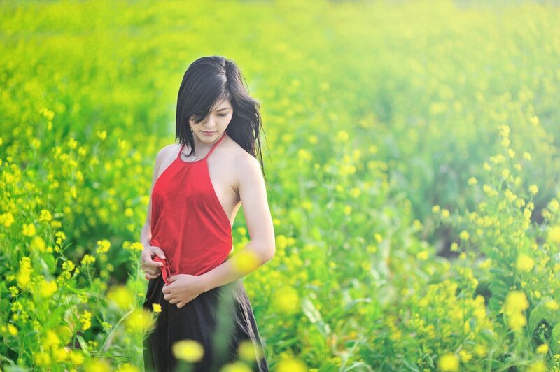 Woman in red top in a field