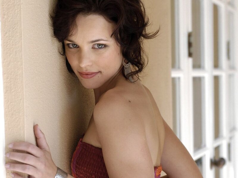 woman in red top leaning on wall
