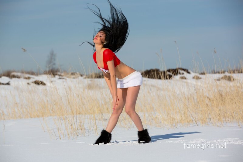 woman in red top on snowy field